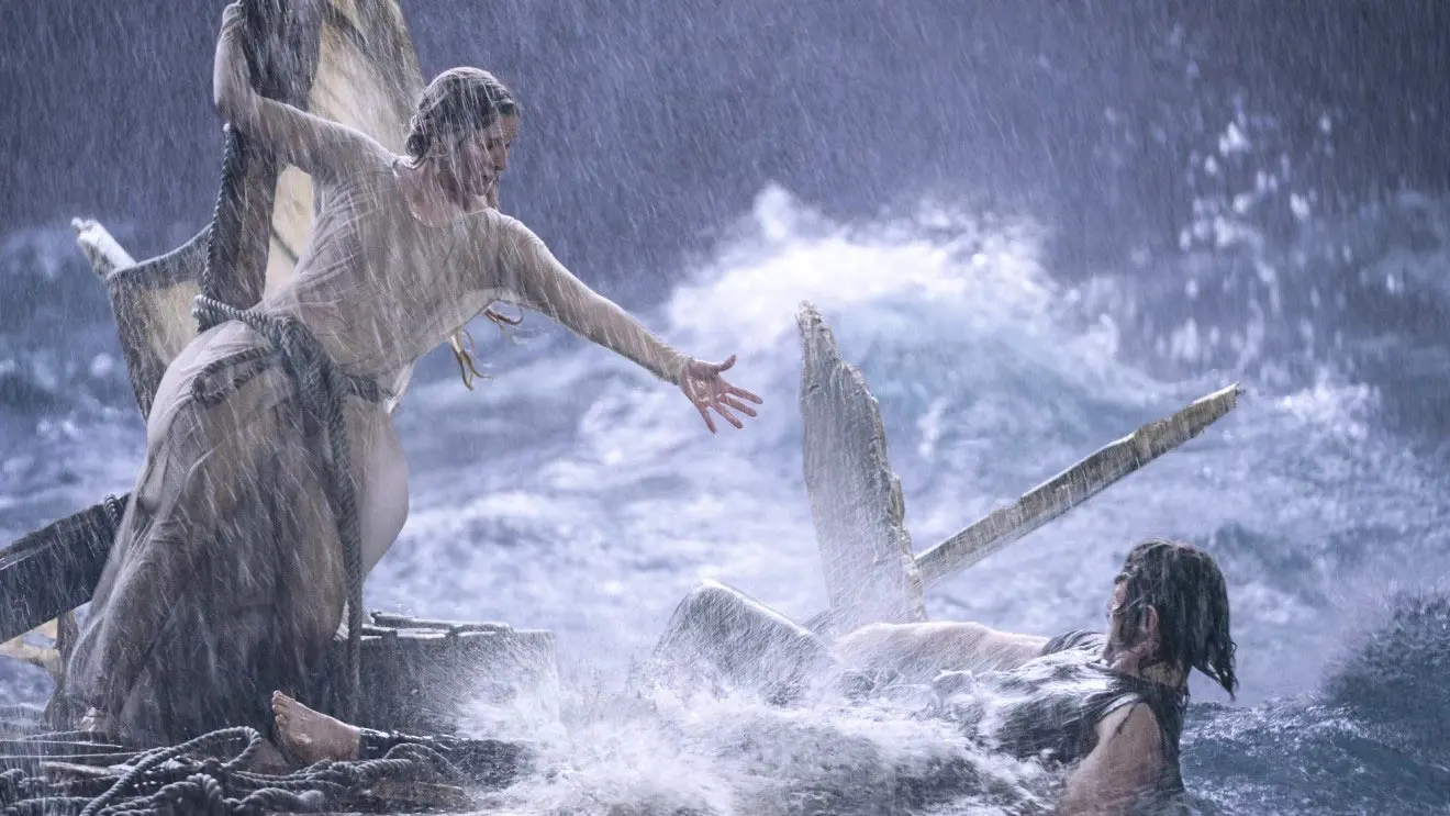 گالادریل در میان طوفان روی تکه های قایق شکسته در حال تلاش برای کمک کردن به کسی